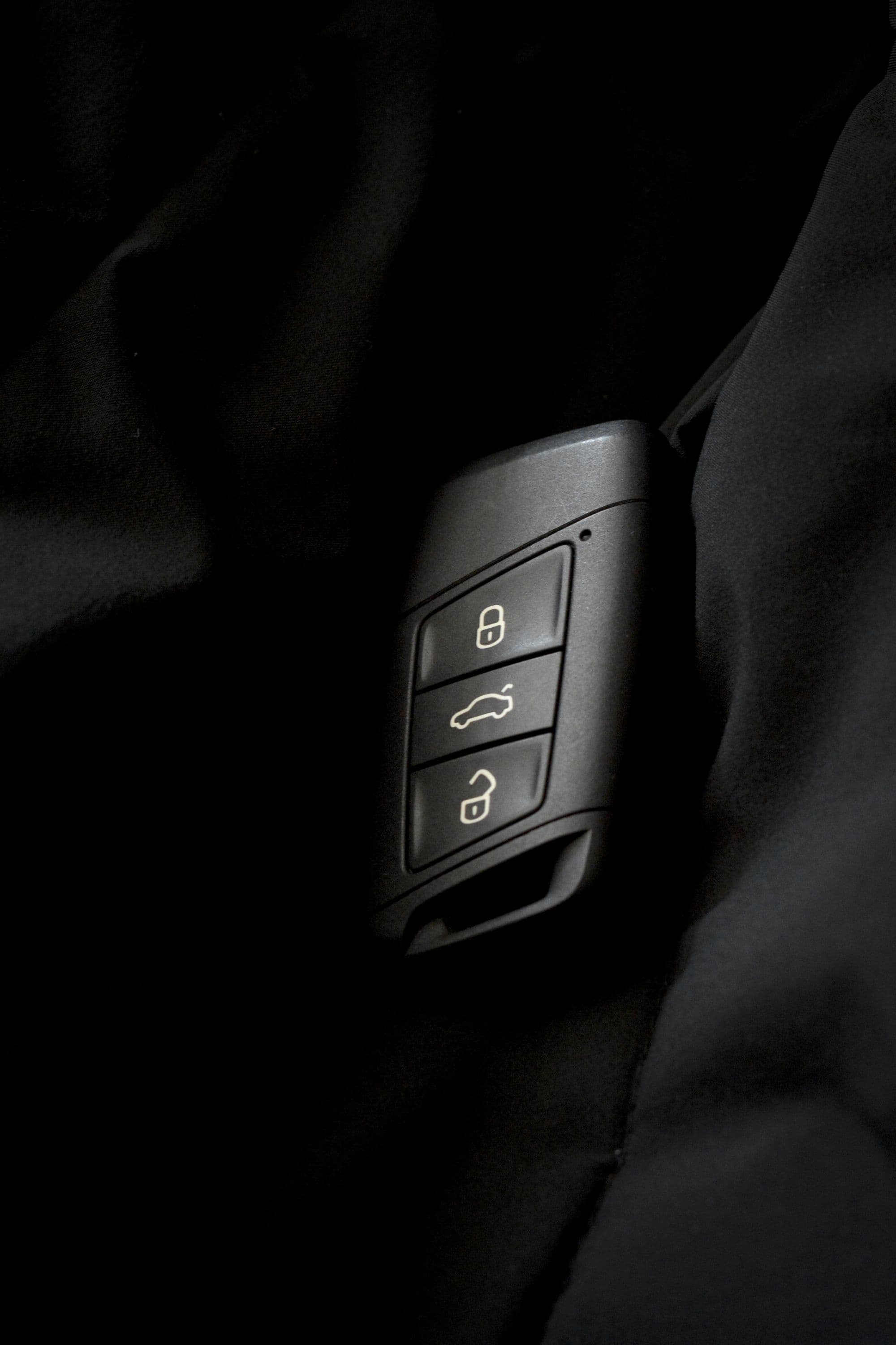 A black proximity car key with no visible metal blade